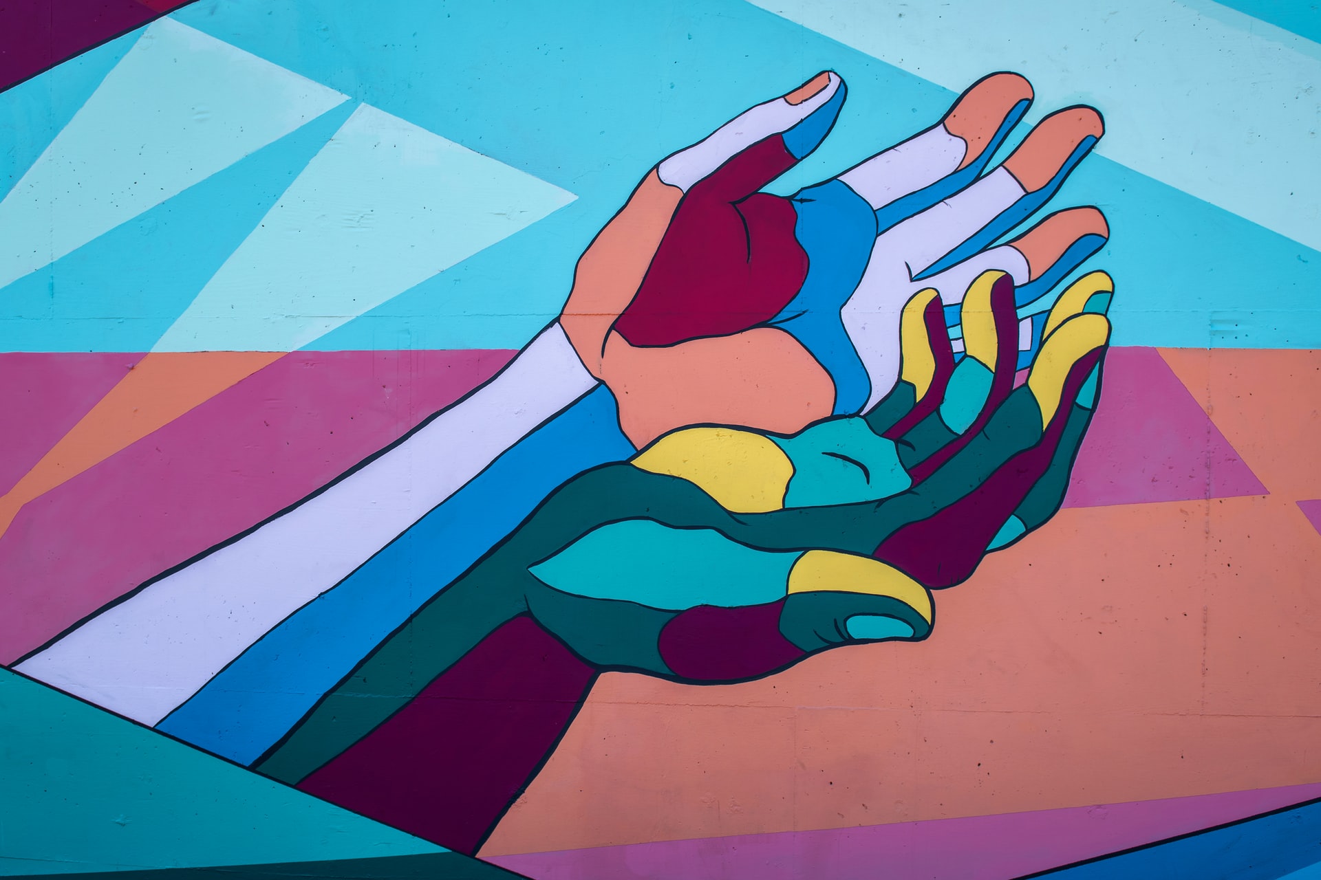 Wall mural of colourful hands with an abstract background