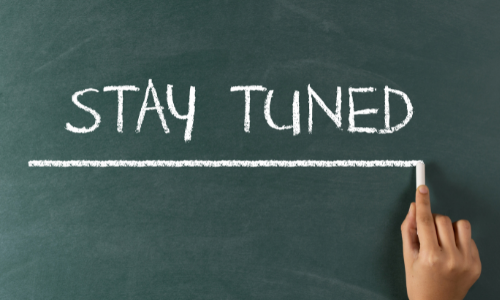 "Stay Tuned" being written on a chalk board