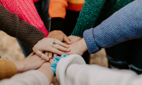 Hands coming together for a huddle