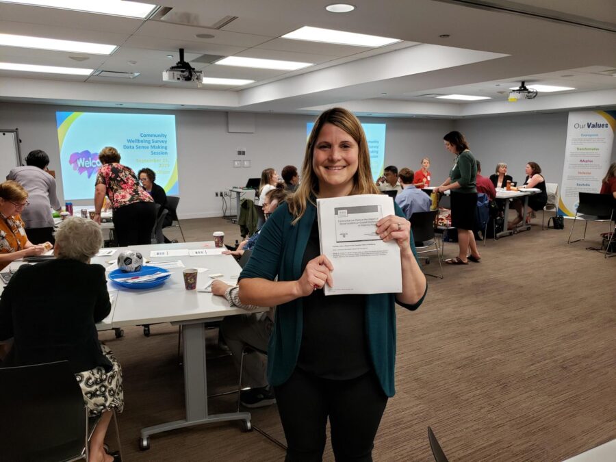 Cheryl holding a report up during a WWR community event