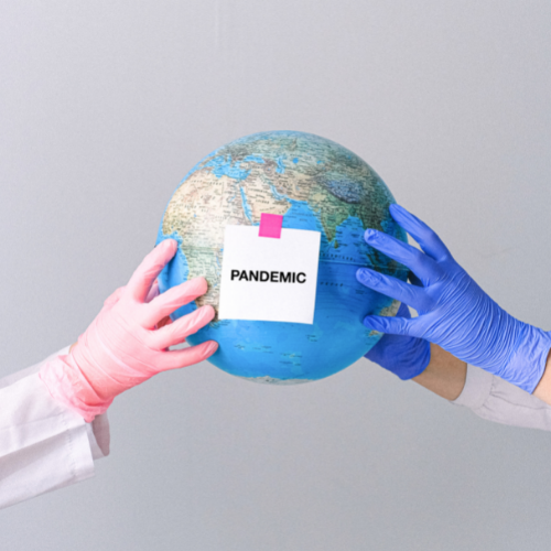 Shifting Graphic Gloved hands holding a globe with the sticky note